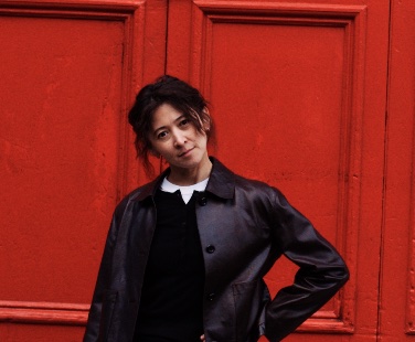 Julia, standing in front of a red door